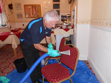 David cleaning a chair